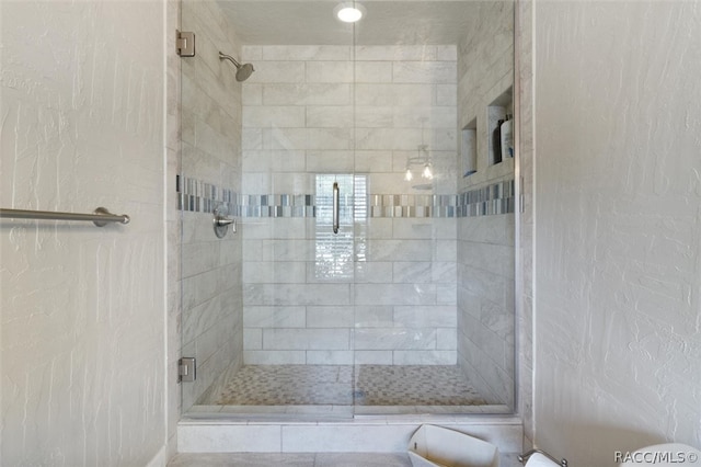 bathroom featuring a shower with door