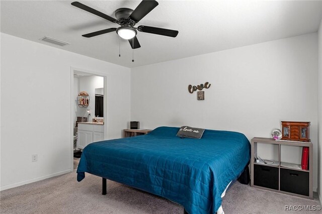 3192 W Barberton Pl, Citrus Springs, FL 34434 - carpeted bedroom featuring baseboards, ensuite bathroom, and a ceiling fan