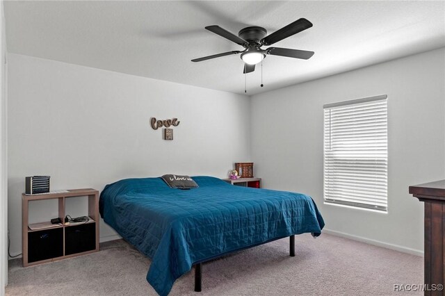 3192 W Barberton Pl, Citrus Springs, FL 34434 - carpeted bedroom with baseboards and ceiling fan