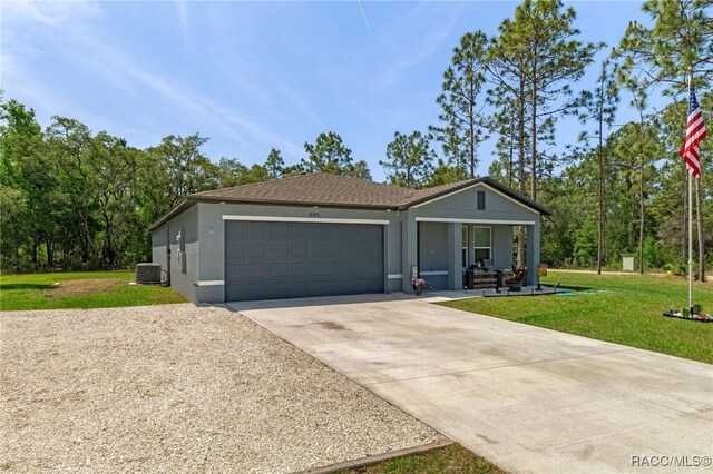 3192 W Barberton Pl, Citrus Springs, FL 34434 - single story home featuring concrete driveway, a front yard, an attached garage, central AC, and stucco siding