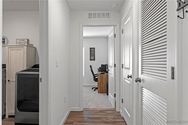 3192 W Barberton Pl, Citrus Springs, FL 34434 - hallway with washer / clothes dryer, dark wood-style floors, an office area, and baseboards