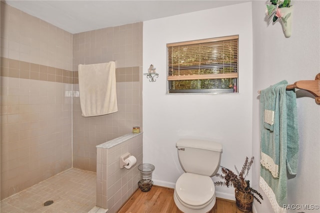 full bath with a walk in shower, baseboards, toilet, and wood finished floors