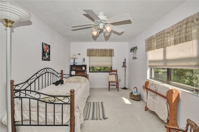 carpeted bedroom featuring a ceiling fan and baseboards