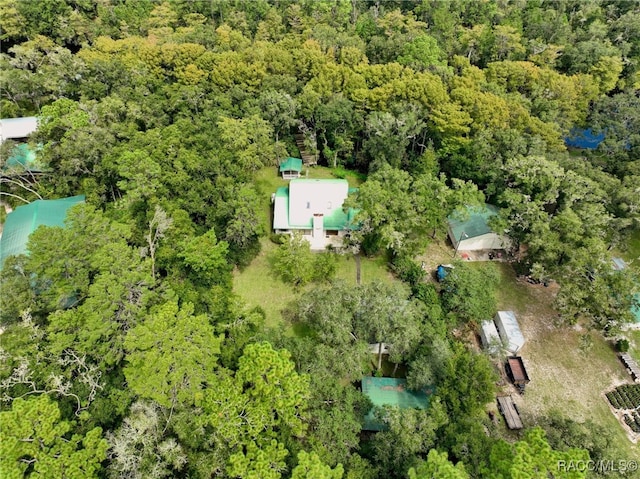 bird's eye view with a wooded view