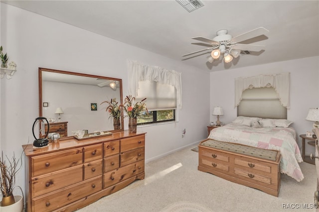 carpeted bedroom with baseboards, visible vents, and ceiling fan