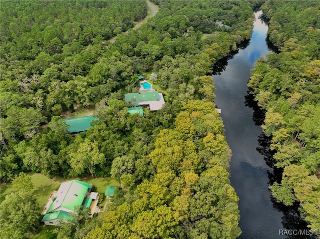 drone / aerial view featuring a water view and a forest view