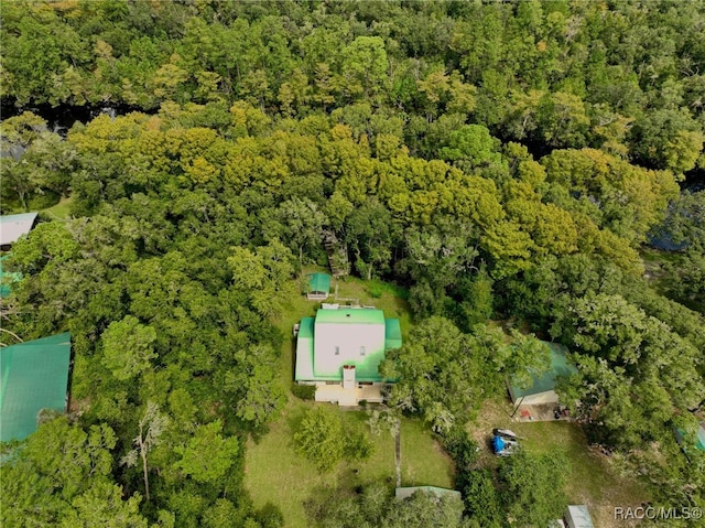 birds eye view of property with a forest view