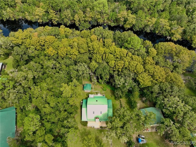 drone / aerial view featuring a wooded view