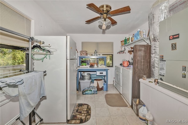 kitchen featuring freestanding refrigerator, ceiling fan, washing machine and clothes dryer, and light tile patterned floors