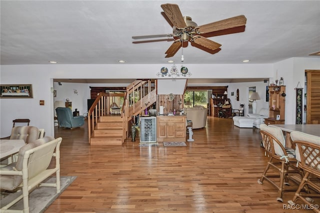 living area with stairs, light wood finished floors, a ceiling fan, and recessed lighting