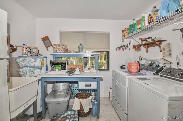 washroom with light tile patterned floors, laundry area, and washer and clothes dryer