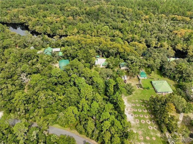 birds eye view of property with a view of trees