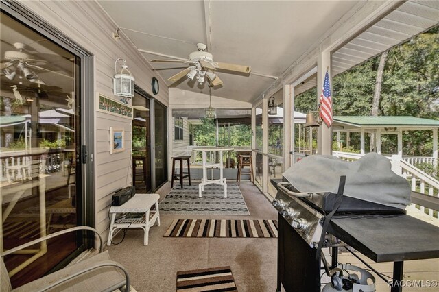 sunroom / solarium featuring vaulted ceiling and a ceiling fan