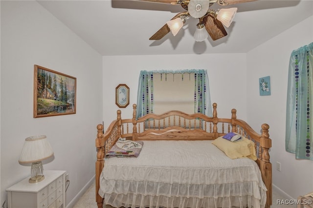 carpeted bedroom featuring baseboards and a ceiling fan