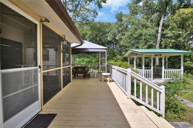 wooden terrace featuring a sunroom