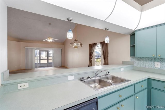 kitchen featuring a wealth of natural light, light countertops, and a sink