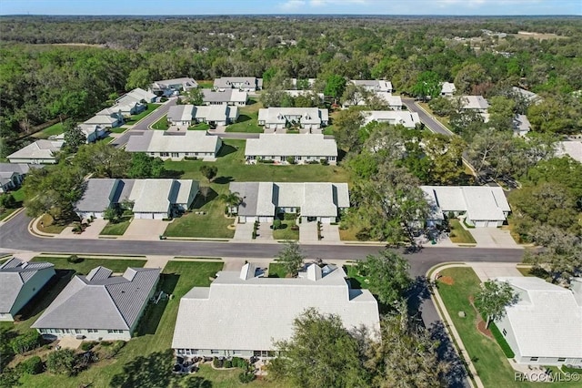 bird's eye view featuring a wooded view and a residential view