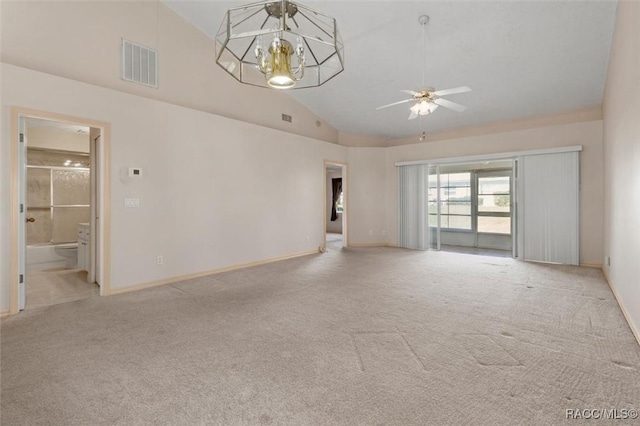 unfurnished living room with visible vents, high vaulted ceiling, ceiling fan with notable chandelier, carpet, and baseboards