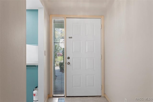 entrance foyer featuring light tile patterned floors and baseboards