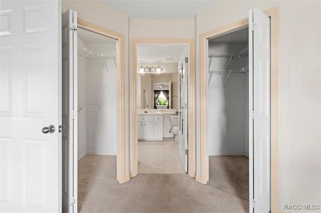 hallway featuring light carpet