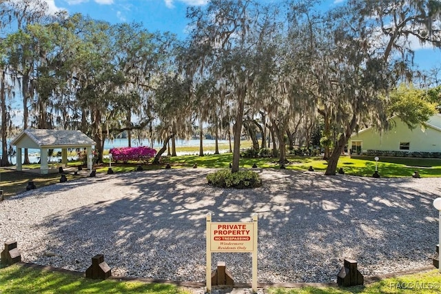 surrounding community featuring a gazebo and a water view