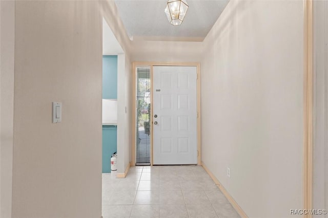 foyer with baseboards and light tile patterned flooring