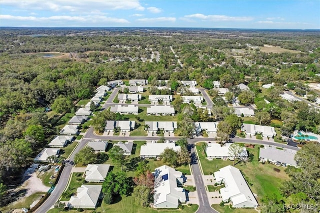 bird's eye view with a wooded view and a residential view