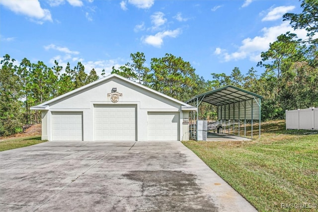 garage with a carport and a yard