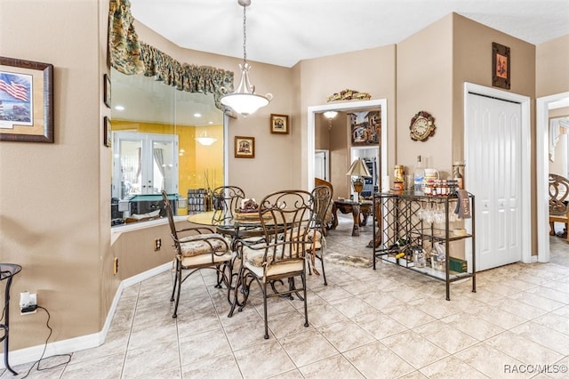 tiled dining room featuring french doors