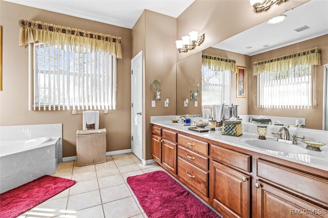 bathroom with tile patterned flooring, vanity, and a bath