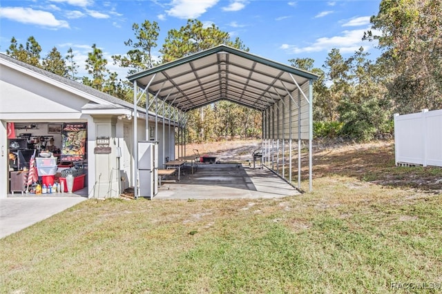 view of vehicle parking featuring a yard and a carport