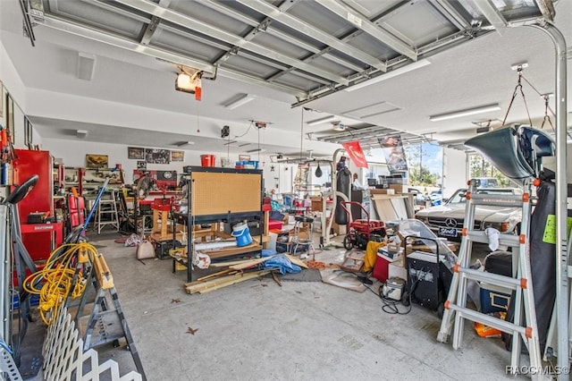 garage with a workshop area and a garage door opener