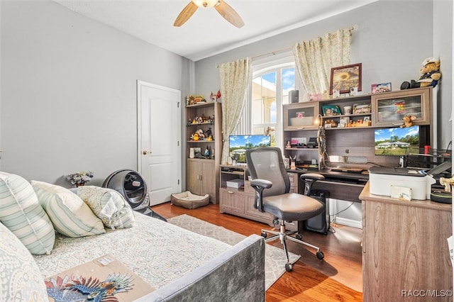 bedroom with hardwood / wood-style floors and ceiling fan