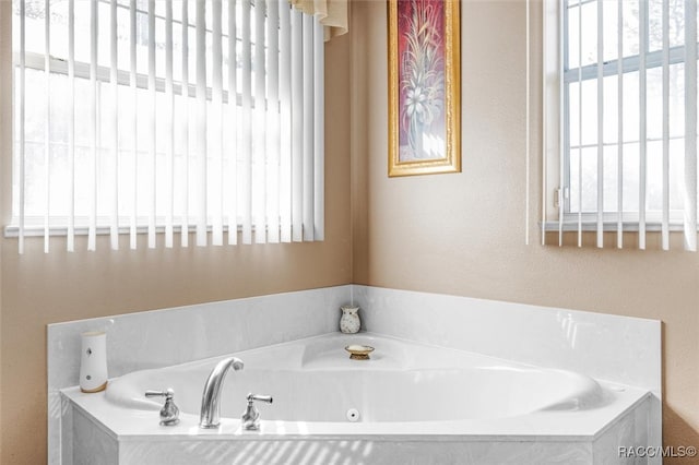 bathroom featuring tiled tub