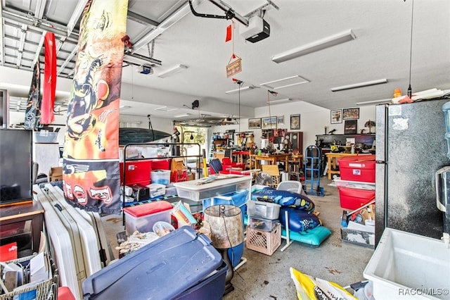 garage featuring black refrigerator and a garage door opener