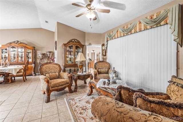 sitting room featuring light tile patterned floors, a textured ceiling, ceiling fan, and lofted ceiling