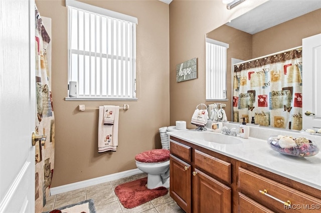 bathroom with tile patterned flooring, vanity, and toilet