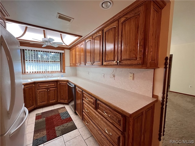 kitchen with stainless steel dishwasher, ceiling fan, sink, light tile patterned floors, and white fridge