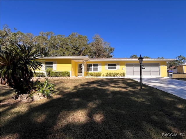 ranch-style home featuring a garage and a front yard