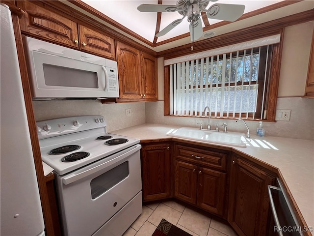 kitchen featuring white appliances, sink, ceiling fan, light tile patterned floors, and ornamental molding