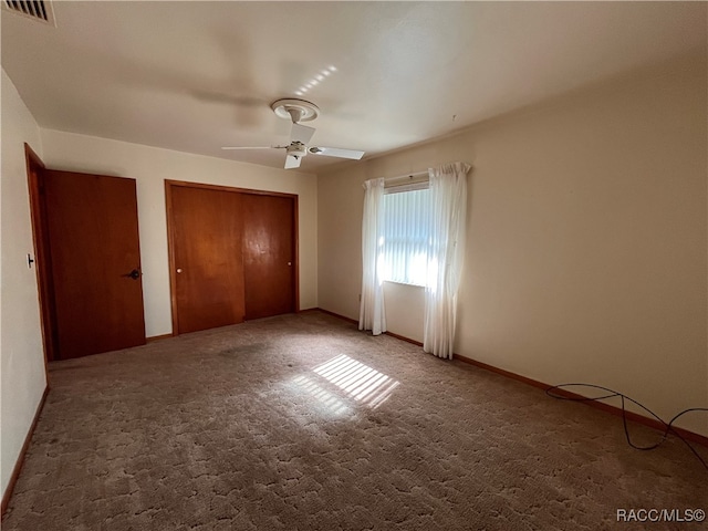 unfurnished bedroom featuring ceiling fan and carpet