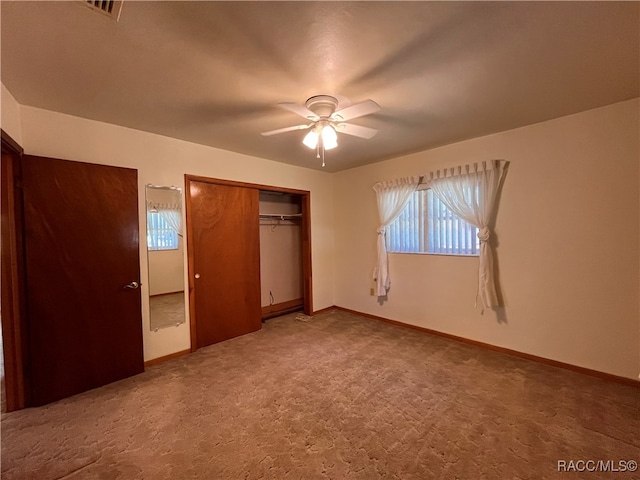 unfurnished bedroom featuring carpet flooring, a closet, and ceiling fan