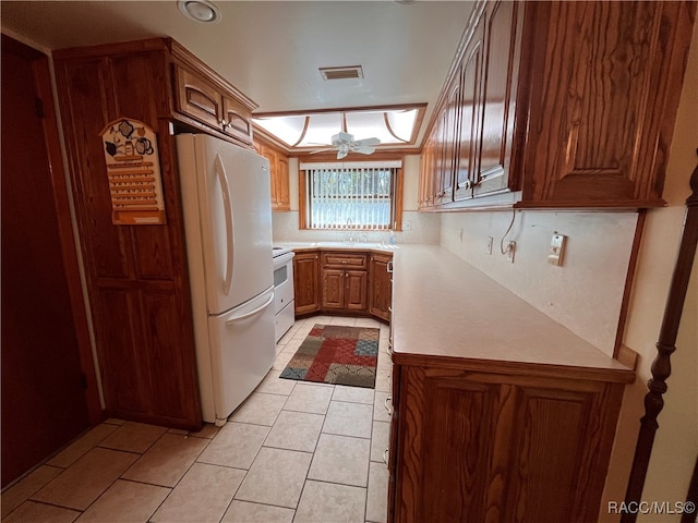 kitchen featuring backsplash, ceiling fan, light tile patterned floors, and white appliances