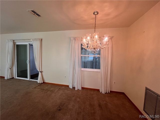 empty room with an inviting chandelier and dark colored carpet