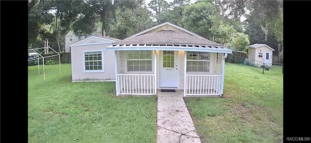 view of outbuilding with a lawn and a porch