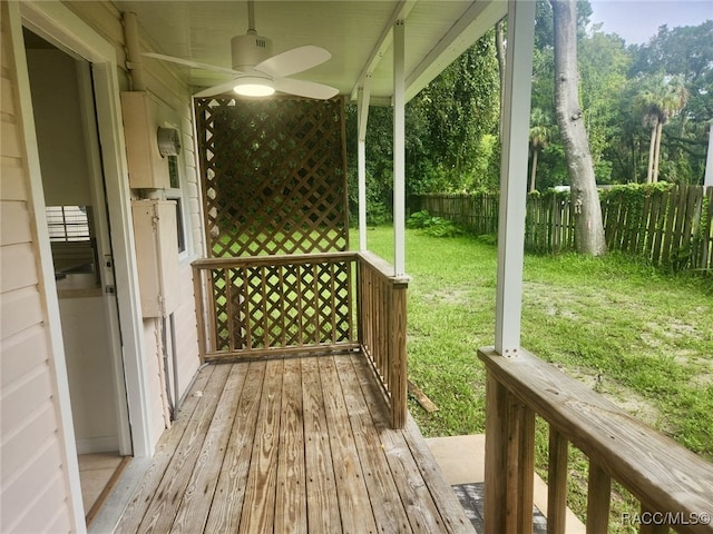 deck with ceiling fan and a yard