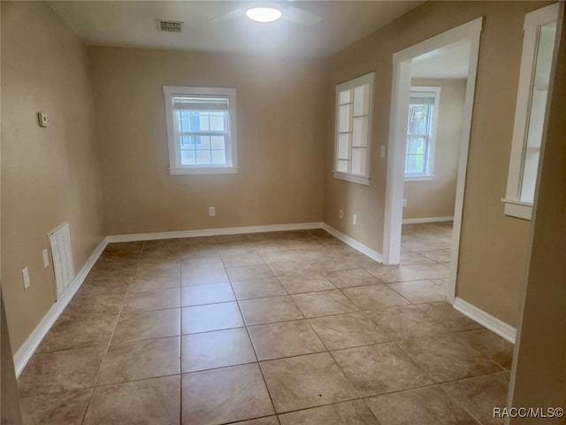 tiled empty room featuring a wealth of natural light