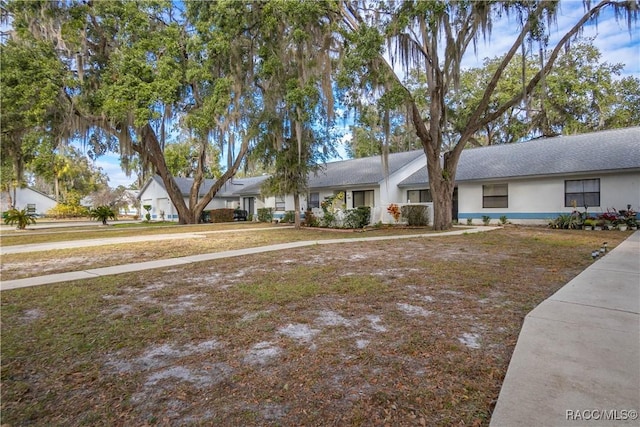 ranch-style house with a front lawn