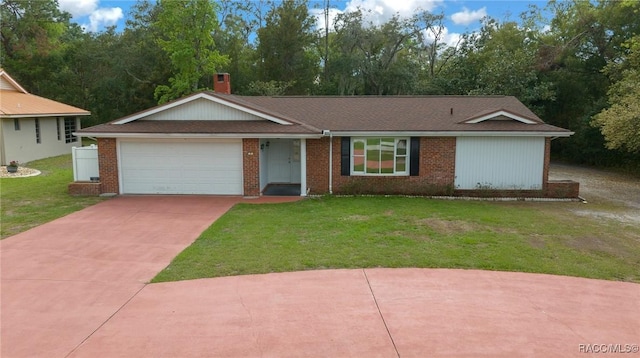 ranch-style house with a garage, concrete driveway, a chimney, a front lawn, and brick siding