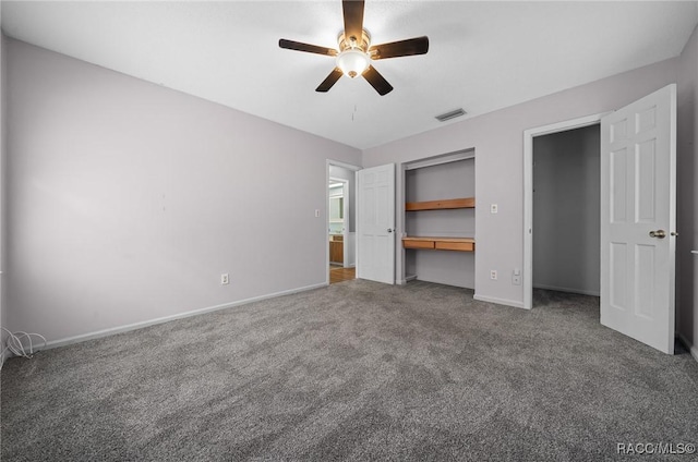 unfurnished bedroom featuring ceiling fan, carpet floors, visible vents, baseboards, and a closet